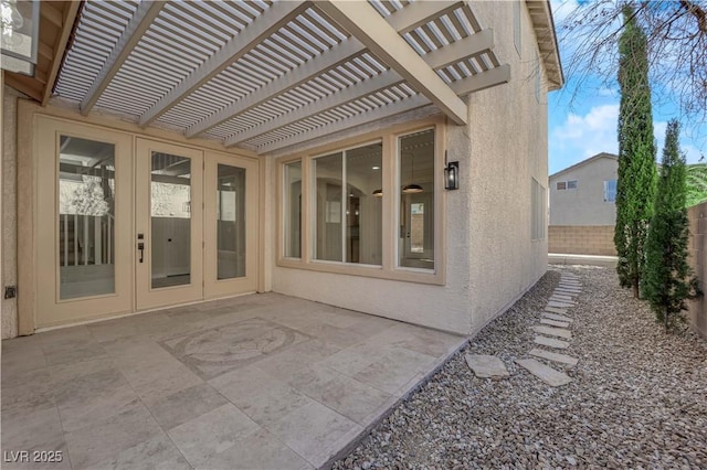 view of patio / terrace featuring french doors, fence, and a pergola