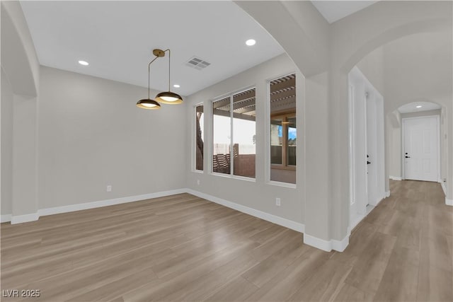 interior space with light wood-style floors, visible vents, baseboards, and recessed lighting