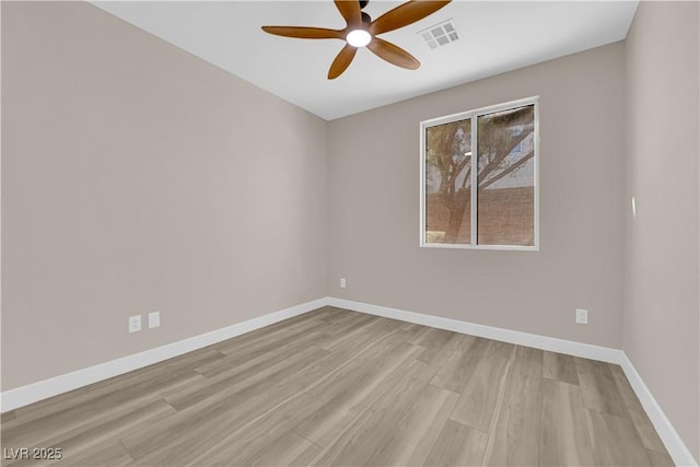 empty room featuring light wood finished floors, visible vents, baseboards, and a ceiling fan