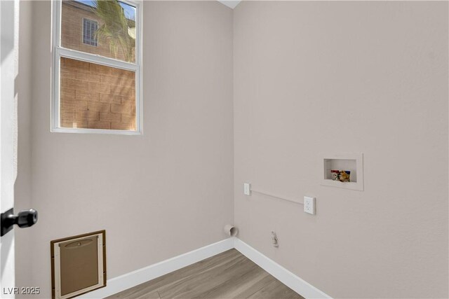 washroom featuring laundry area, hookup for a washing machine, wood finished floors, and baseboards