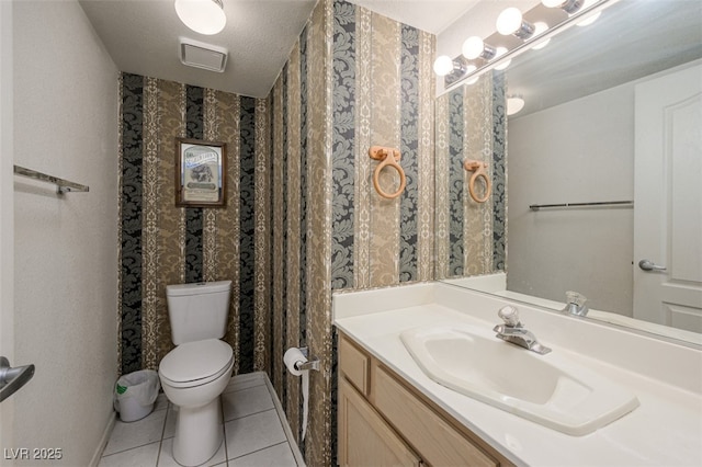 bathroom featuring vanity, tile patterned flooring, toilet, and wallpapered walls