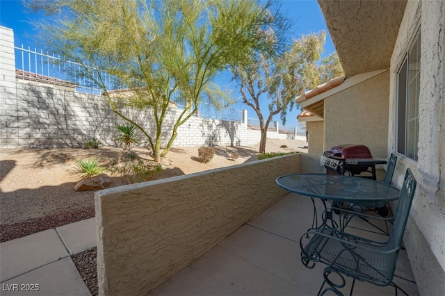 view of patio featuring a balcony and grilling area