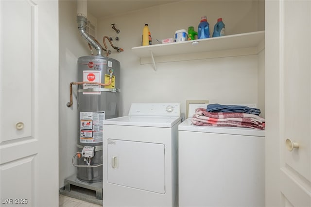 clothes washing area with gas water heater, independent washer and dryer, and laundry area