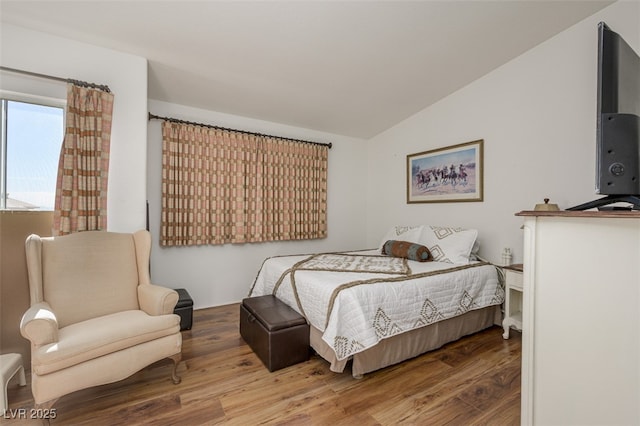 bedroom featuring vaulted ceiling and wood finished floors