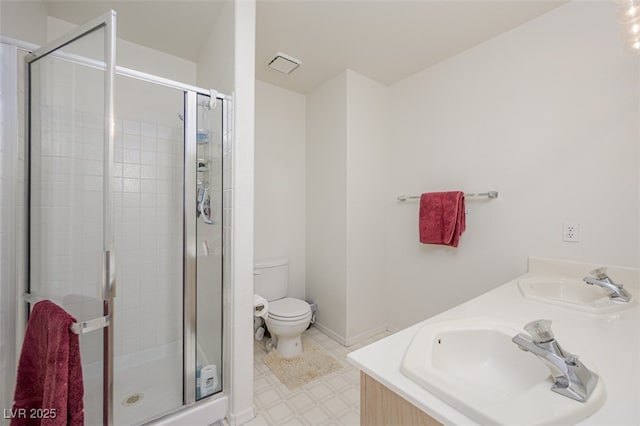 full bathroom with a sink, a shower stall, and toilet