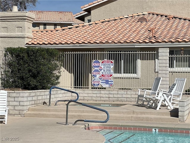 exterior space featuring a tiled roof