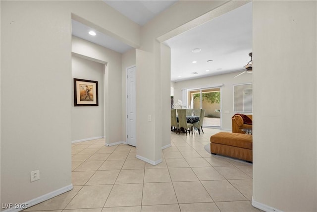 interior space with light tile patterned floors, baseboards, and recessed lighting