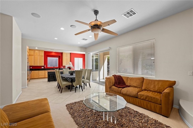 living area with light tile patterned floors, baseboards, visible vents, and recessed lighting