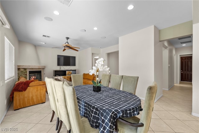 dining area featuring light tile patterned floors, a fireplace, visible vents, and recessed lighting