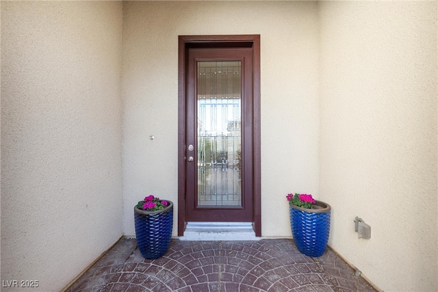 doorway to property with stucco siding