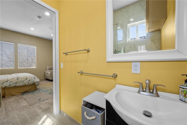 ensuite bathroom featuring a sink and ensuite bath