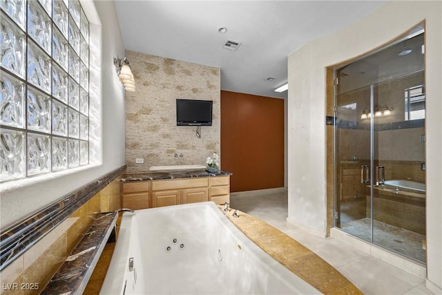 full bathroom with a stall shower, visible vents, tile patterned floors, a jetted tub, and vanity