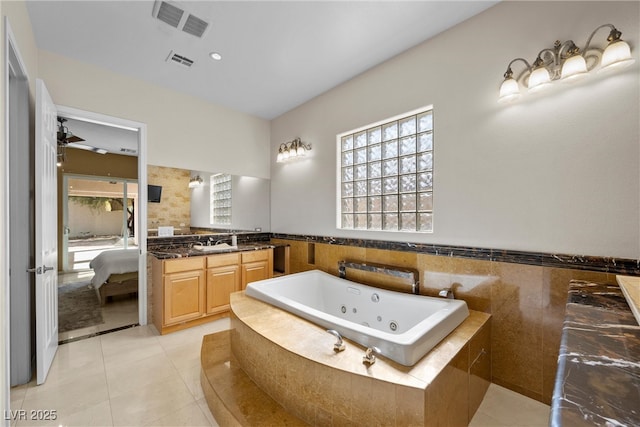 full bathroom with tile patterned flooring, visible vents, vanity, and a whirlpool tub