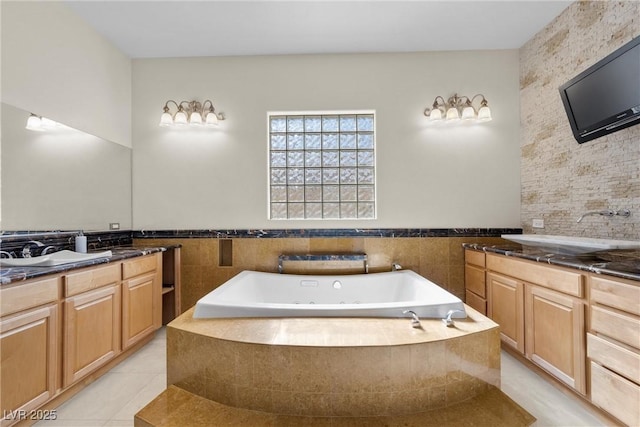 full bathroom with a garden tub, two vanities, and a sink