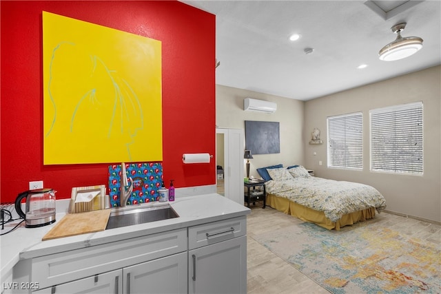 bedroom featuring recessed lighting, a sink, and a wall mounted air conditioner