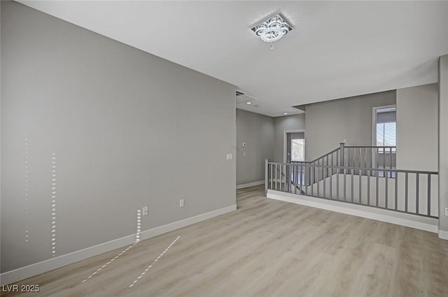 spare room featuring wood finished floors and baseboards