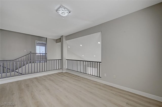 empty room with wood finished floors and baseboards