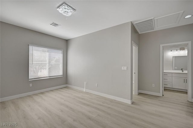 unfurnished bedroom featuring light wood-type flooring, visible vents, and baseboards