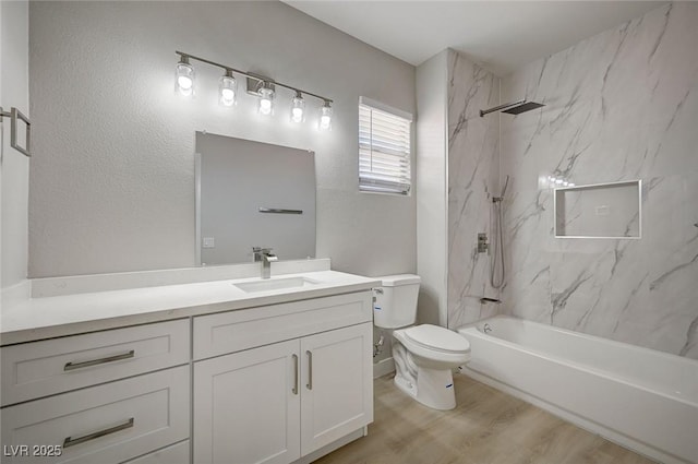 bathroom featuring toilet, a combined bath / shower with marble appearance, wood finished floors, and vanity