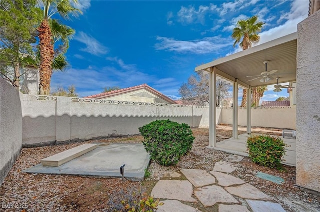 view of yard with a patio area, a fenced backyard, and ceiling fan