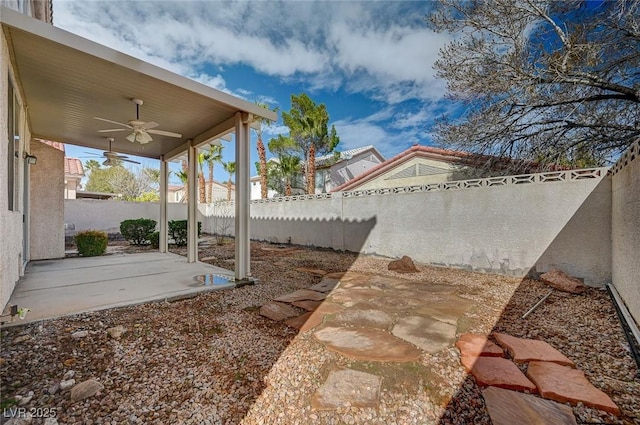 view of yard featuring a fenced backyard, a patio, and ceiling fan