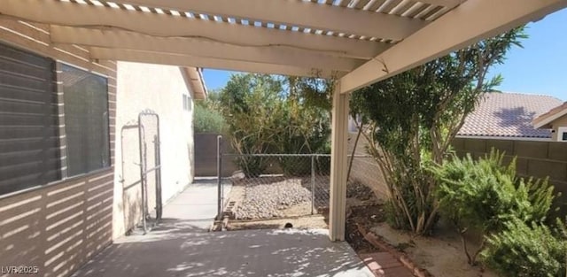 view of patio / terrace featuring fence and a pergola