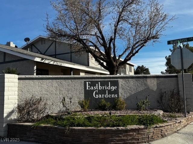 community / neighborhood sign featuring fence