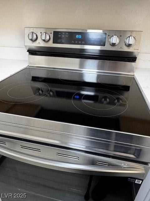 details with light countertops and stainless steel electric stove