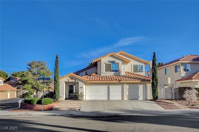 mediterranean / spanish home with stucco siding, fence, concrete driveway, and a tiled roof