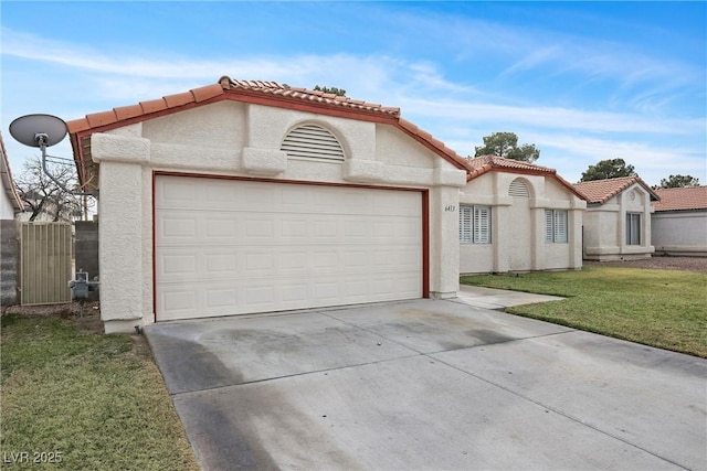 mediterranean / spanish-style home with driveway, a tiled roof, a garage, and stucco siding