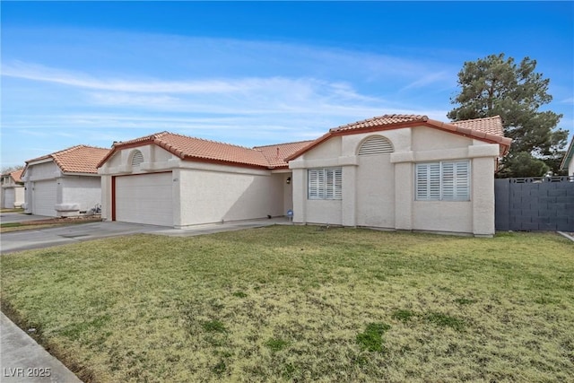 mediterranean / spanish-style home with driveway, an attached garage, fence, a front lawn, and stucco siding