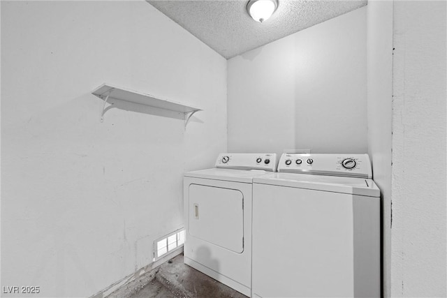 laundry area featuring a textured ceiling, laundry area, visible vents, and washer and dryer