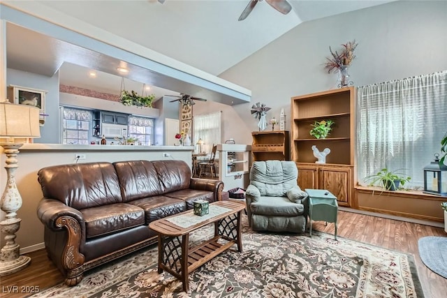 living room featuring ceiling fan, vaulted ceiling, and wood finished floors