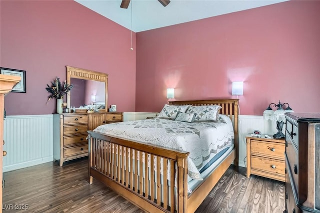 bedroom with a wainscoted wall, a ceiling fan, and wood finished floors