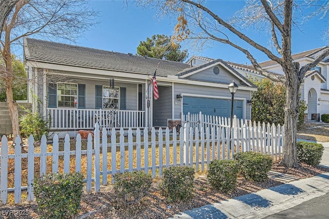 view of front of home featuring an attached garage, covered porch, a fenced front yard, and a tile roof