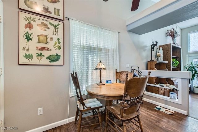 dining room featuring ceiling fan, wood finished floors, and baseboards