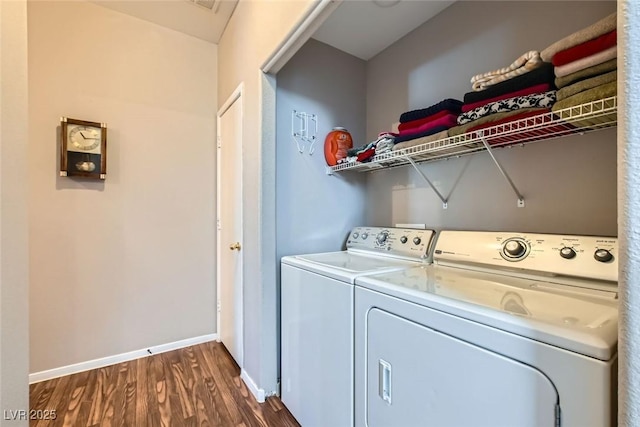 laundry room featuring dark wood-style floors, laundry area, baseboards, and separate washer and dryer