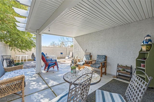 view of patio featuring fence and a pergola