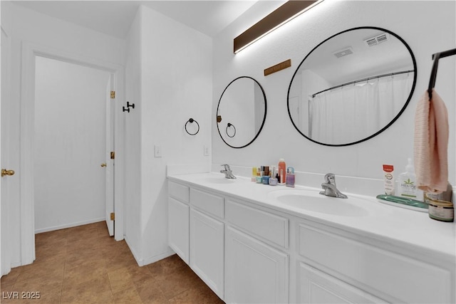 bathroom with visible vents, a sink, and double vanity