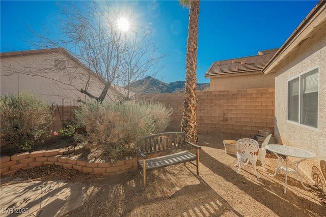 view of patio featuring a fenced backyard and a mountain view