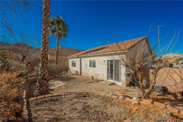 back of property featuring a patio area, fence, and stucco siding