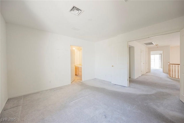 spare room with visible vents and light colored carpet