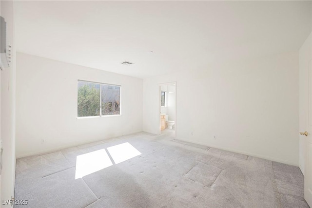 carpeted empty room with visible vents