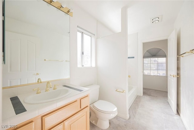 bathroom featuring vanity, toilet, and bathing tub / shower combination