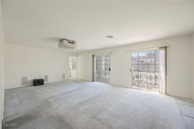 spare room featuring carpet floors and visible vents