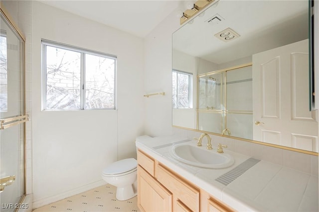 full bath with visible vents, a shower with door, vanity, and toilet