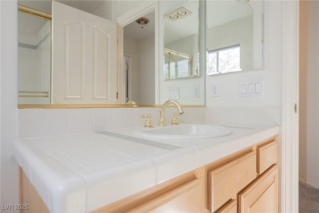 full bathroom with vanity and a shower with door