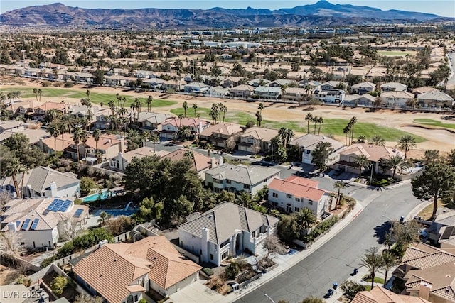 aerial view with a residential view, a mountain view, and golf course view