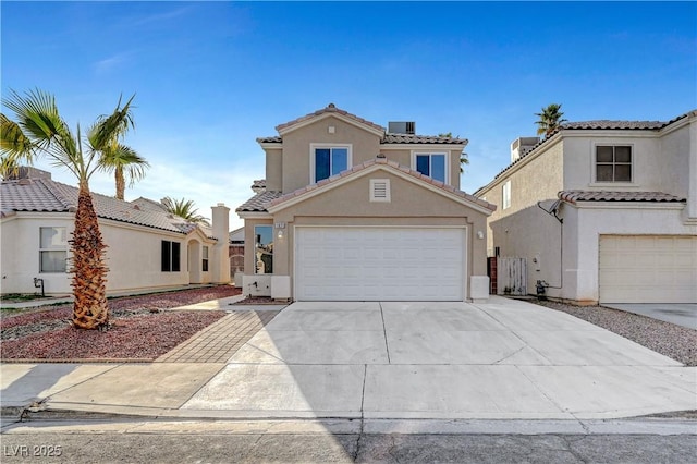 mediterranean / spanish-style home featuring driveway, a tiled roof, central AC unit, and stucco siding