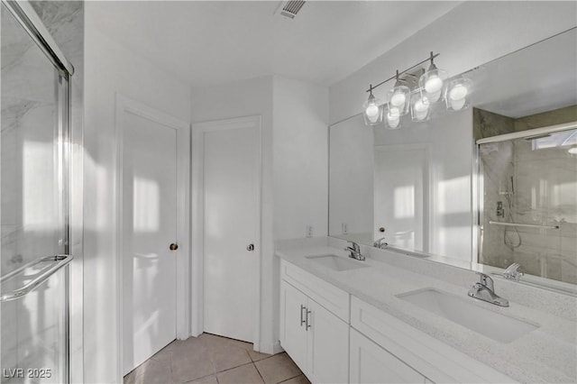 full bath featuring a shower stall, visible vents, a sink, and tile patterned floors